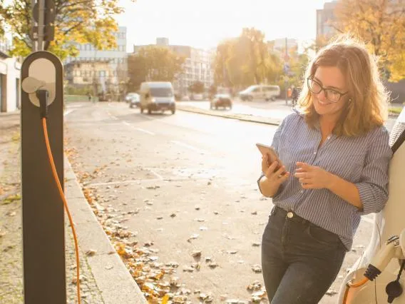 woman charging an electric car