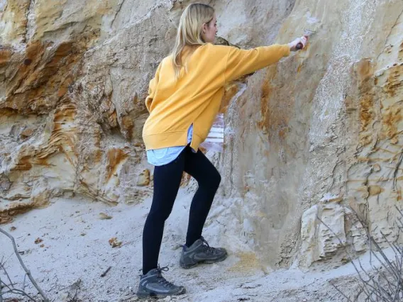 someone looking at a rock