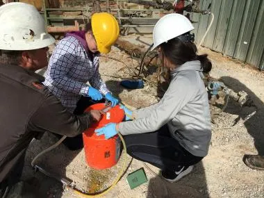 PhD students Jihyun Kim and Rebecca Tyne sample deep basinal brines for noble gas isotope analyses