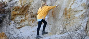 someone looking at a rock